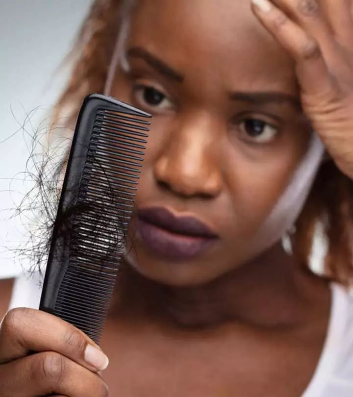 Woman examining hair shedding in bathroom mirror during morning routine — hair loss solution for women