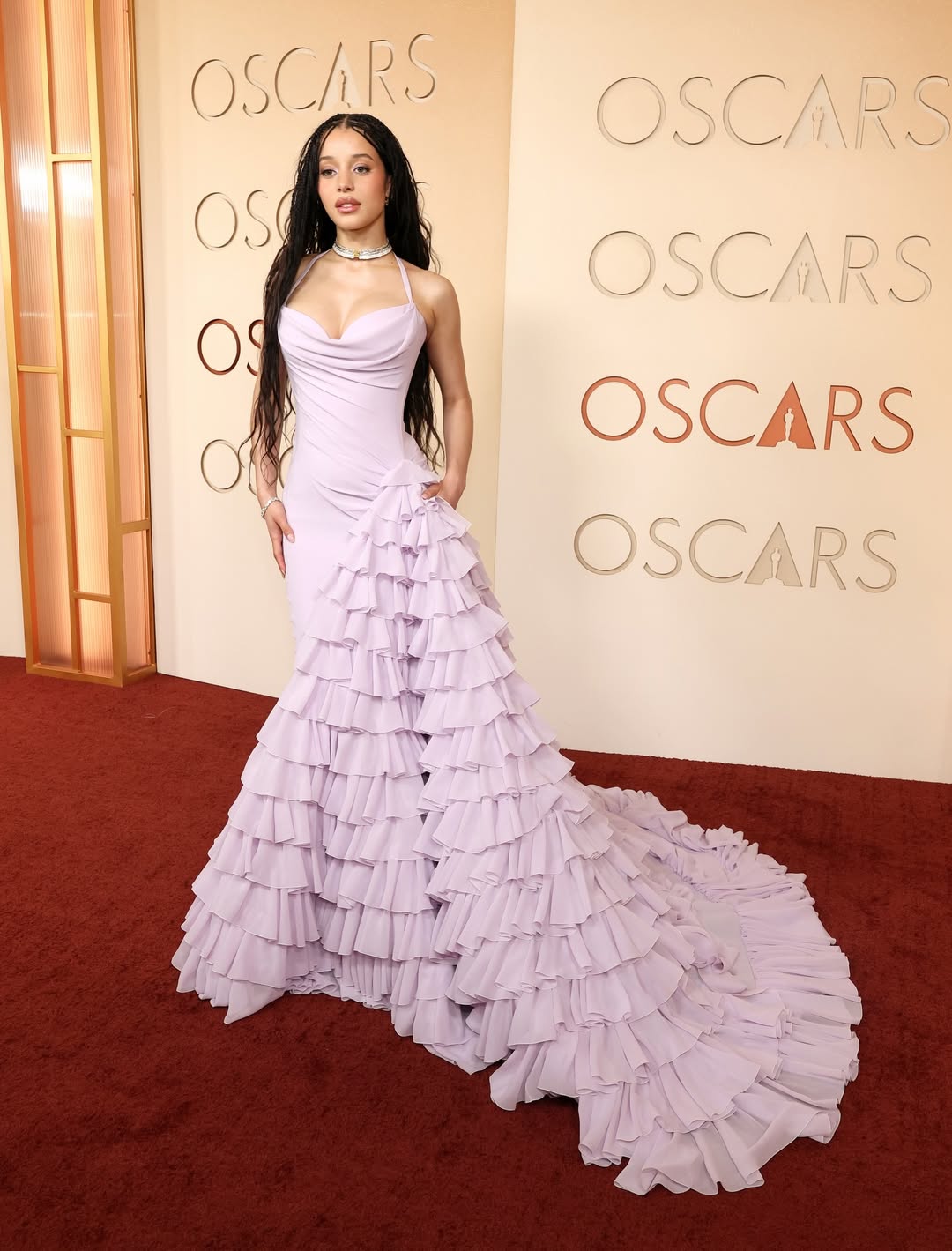Chase Infiniti in a custom lavender Louis Vuitton gown with tiered ruffle skirt on the Oscars 2026 red carpet.