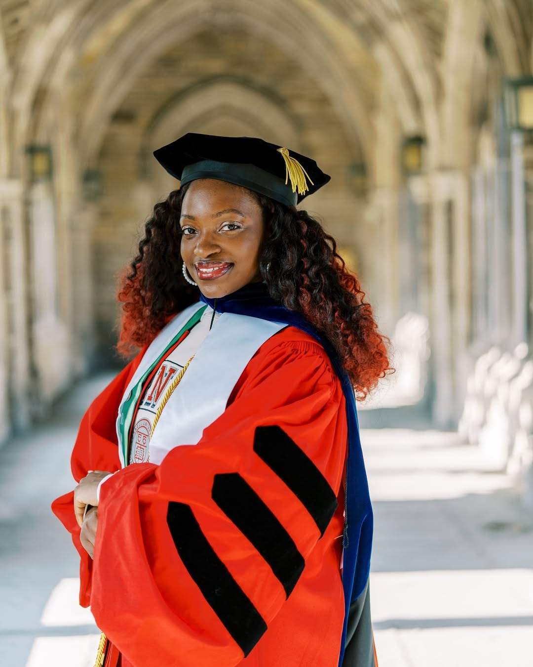 Chinasa T. Okolo in her doctoral regalia at Cornell University, celebrating her historic achievement as the first Nigerian to defend a PhD in Computer Science at the institution.