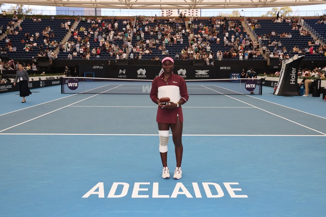 Victoria Mboko holding her runner-up trophy at Memorial Drive Tennis Centre after the 2026 Adelaide International final.