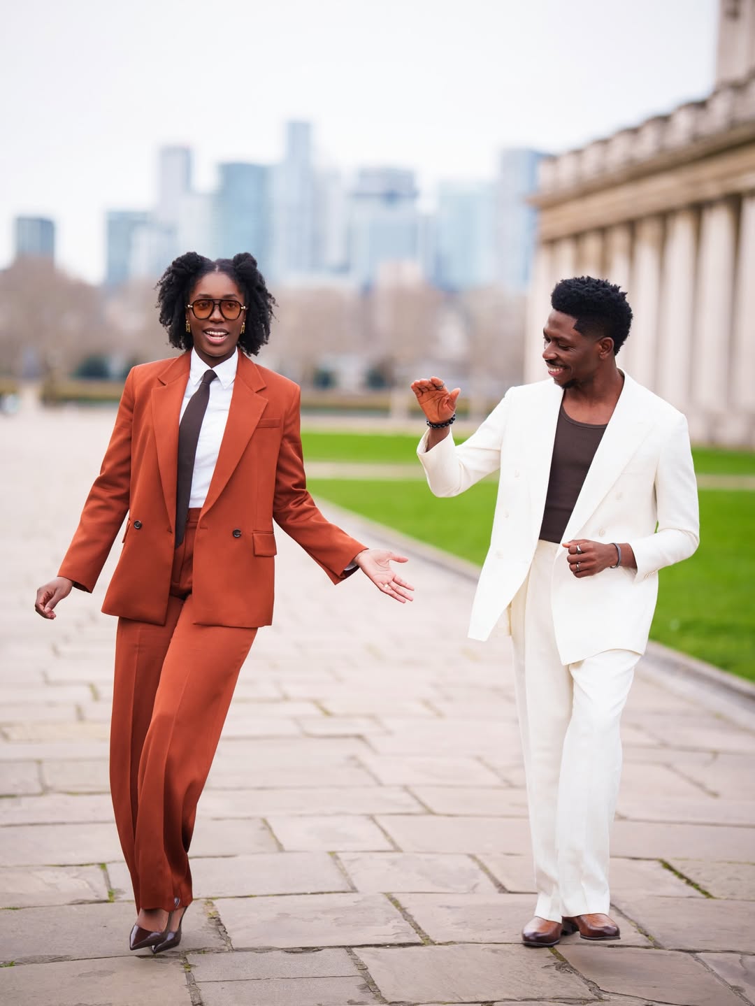 Moses Bliss in a cream double-breasted suit and Marie Bliss in a rust-coloured oversized power suit for their second wedding anniversary.