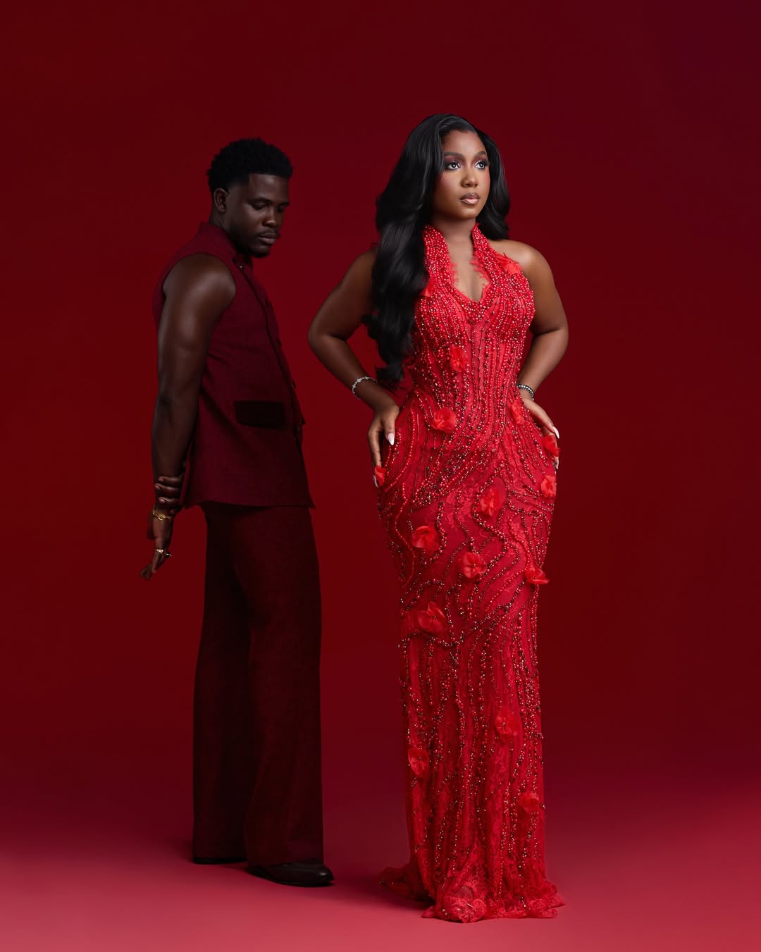 Simi Sanya in a crystal-beaded red floral gown and Femi Dapson in a deep burgundy suit for their 2026 pre-wedding photo shoot.