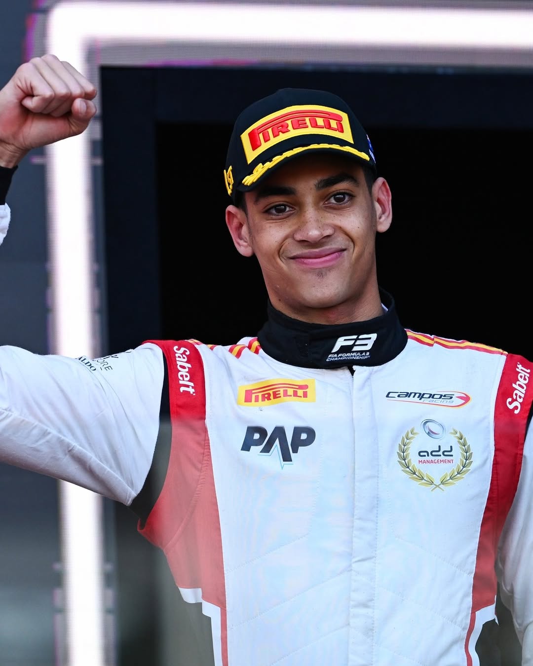 Close-up of a smiling Ugo Ugochukwu in his Campos Racing gear pumping his fist after securing his first FIA Formula 3 win in Melbourne.