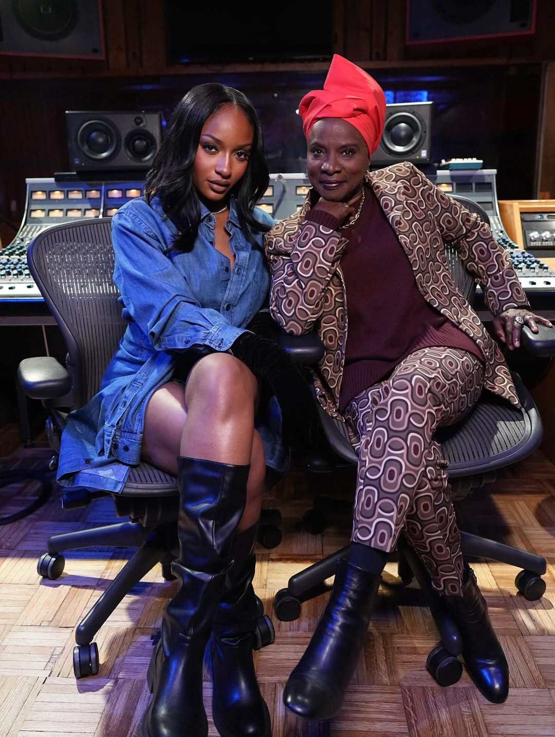 Angélique Kidjo and Ayra Starr sitting in a recording studio for their Aye Kan collaboration.