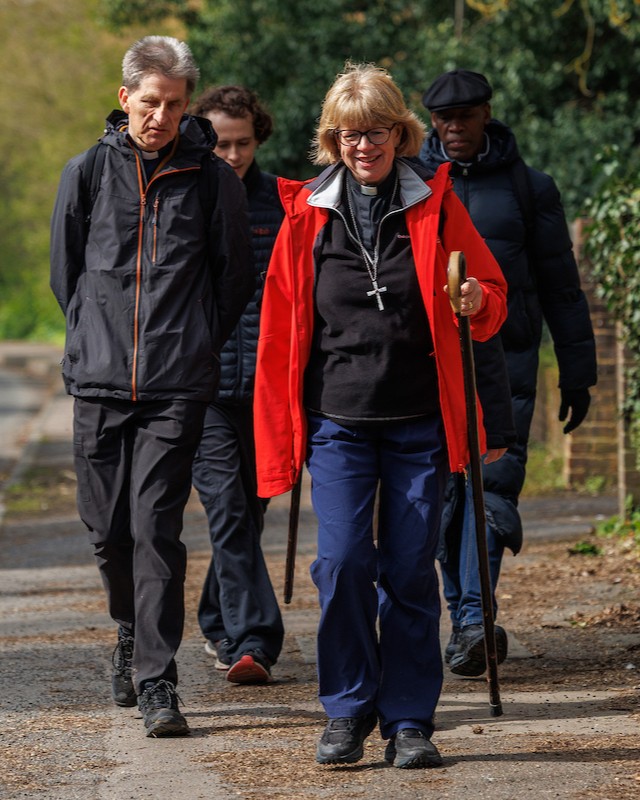 Dame Sarah Mullally in hiking gear and a red jacket during her 87-mile pilgrimage to Canterbury.