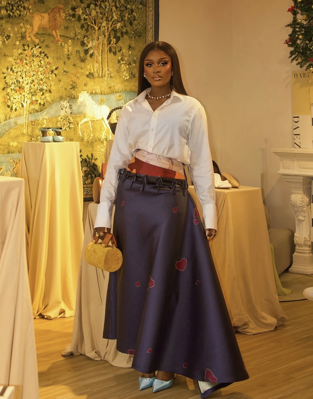 Cropped white shirt styled with a navy A-line maxi skirt and silk scarf at the waist — A-line maxi skirt styling tips