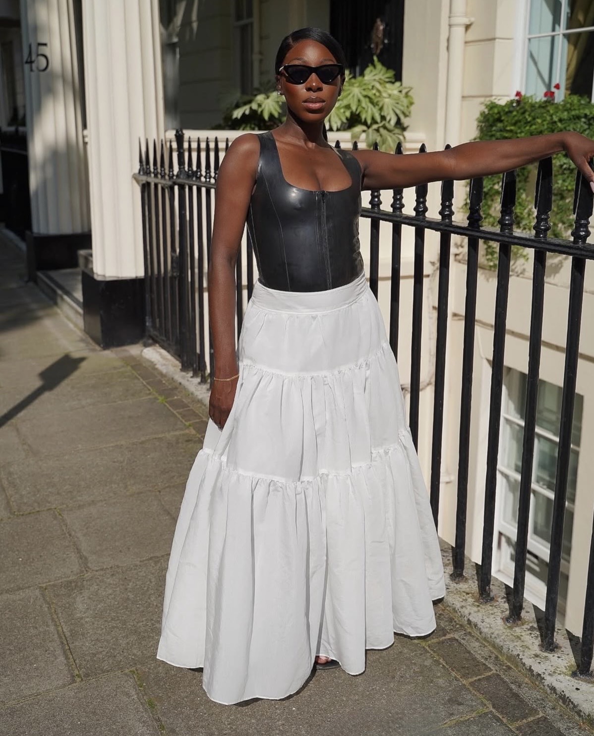 Black corset top styled with voluminous white tiered maxi skirt outfit— A-line maxi skirt styling tips