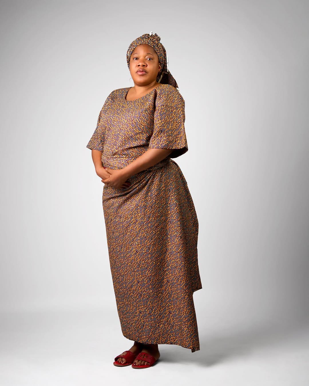 Toyin Abraham Ajeyemi dressed in a traditional patterned iro and buba with a matching headtie for her role in Alakada Gen Z.