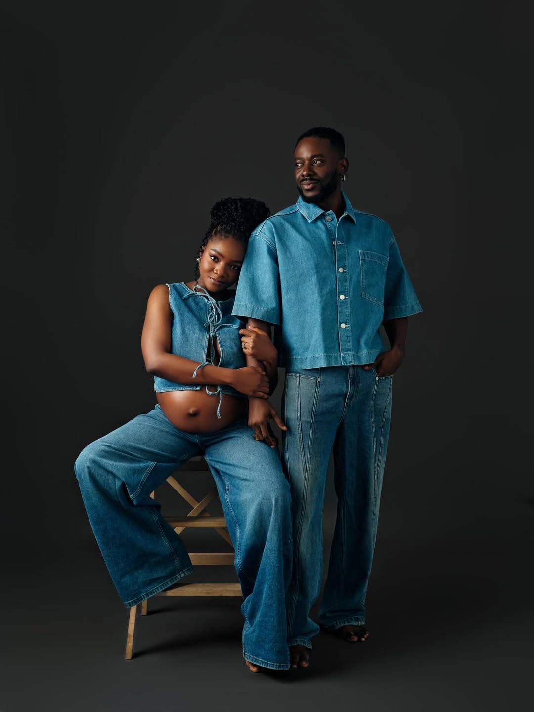Adekunle Gold and Simi posing in a denim-themed pregnancy photoshoot for their son, who was born on 10th March 2026.