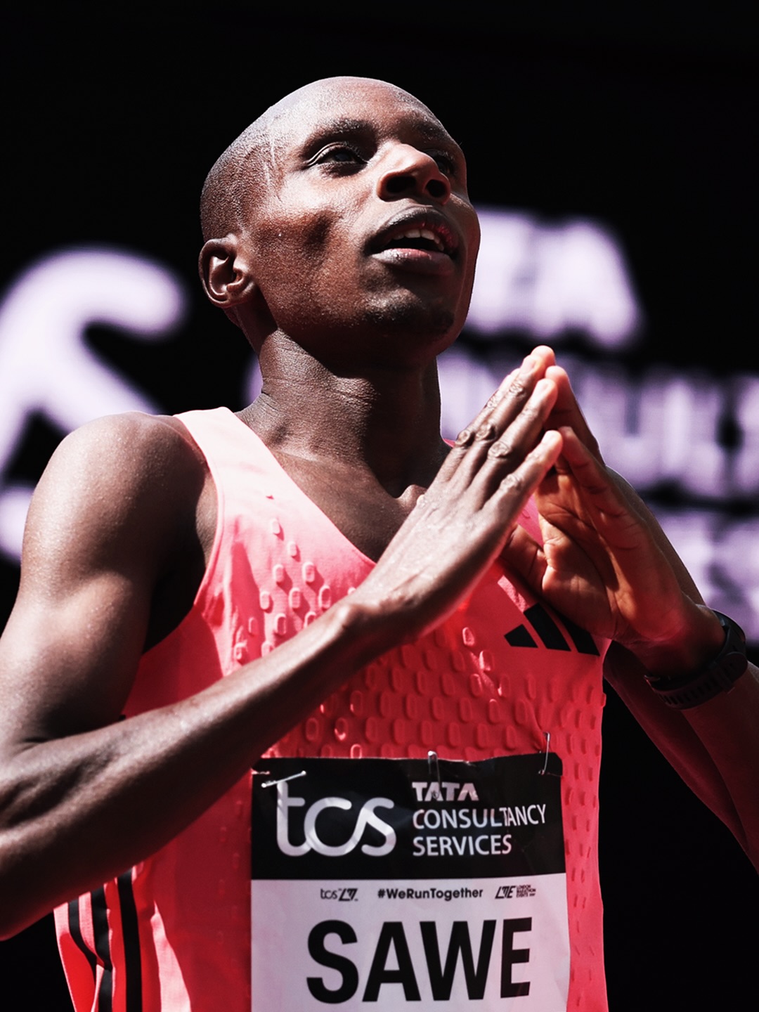Kenyan athlete Sabastian Sawe celebrating his world record 1:59:30 finish at the 2026 London Marathon.