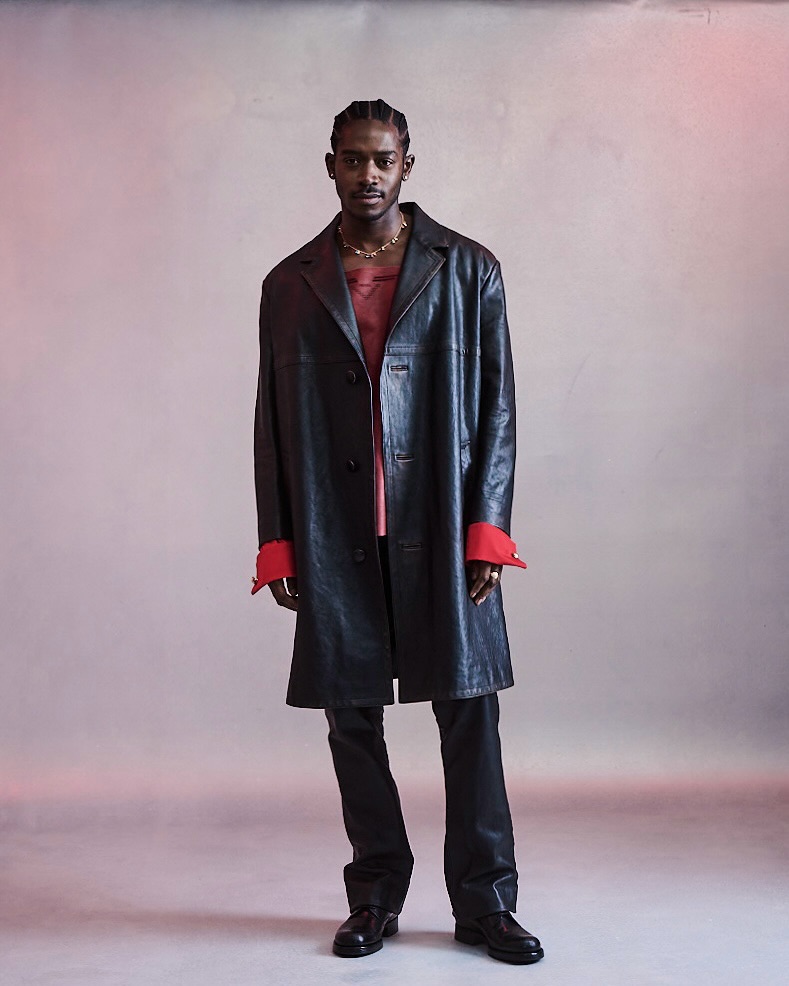 Prada Ambassador Damson Idris in a black leather coat with red poplin tuxedo cuffs at the 2026 Met Gala.