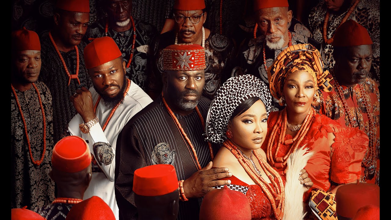 Movie poster for ‘The Serpent’s Gift’ featuring Linda Ejiofor, Stan Nze, Tina Mba, and Daniel Etim Effiong in traditional Igbo attire including red caps and coral beads.