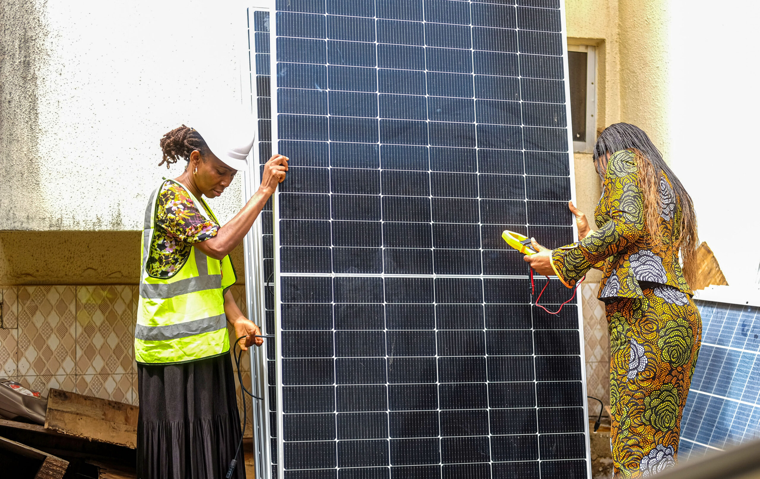 Nkechi Okenwa, CEO of Energy Excell Systems and Solutions, and Anita Manuel, an entrepreneur and contractor checking solar panels at CITEC Estate by Jabi-Airport Road bypass, FCT Abuja, Nigeria on April, 1, 2026. Photo: Jerry Ogbe, bird story agency