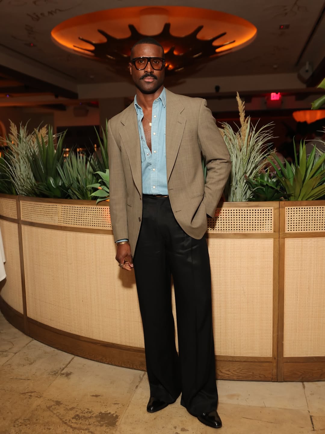 Professional man in soft-shouldered blazer and quality trousers demonstrating power dressing