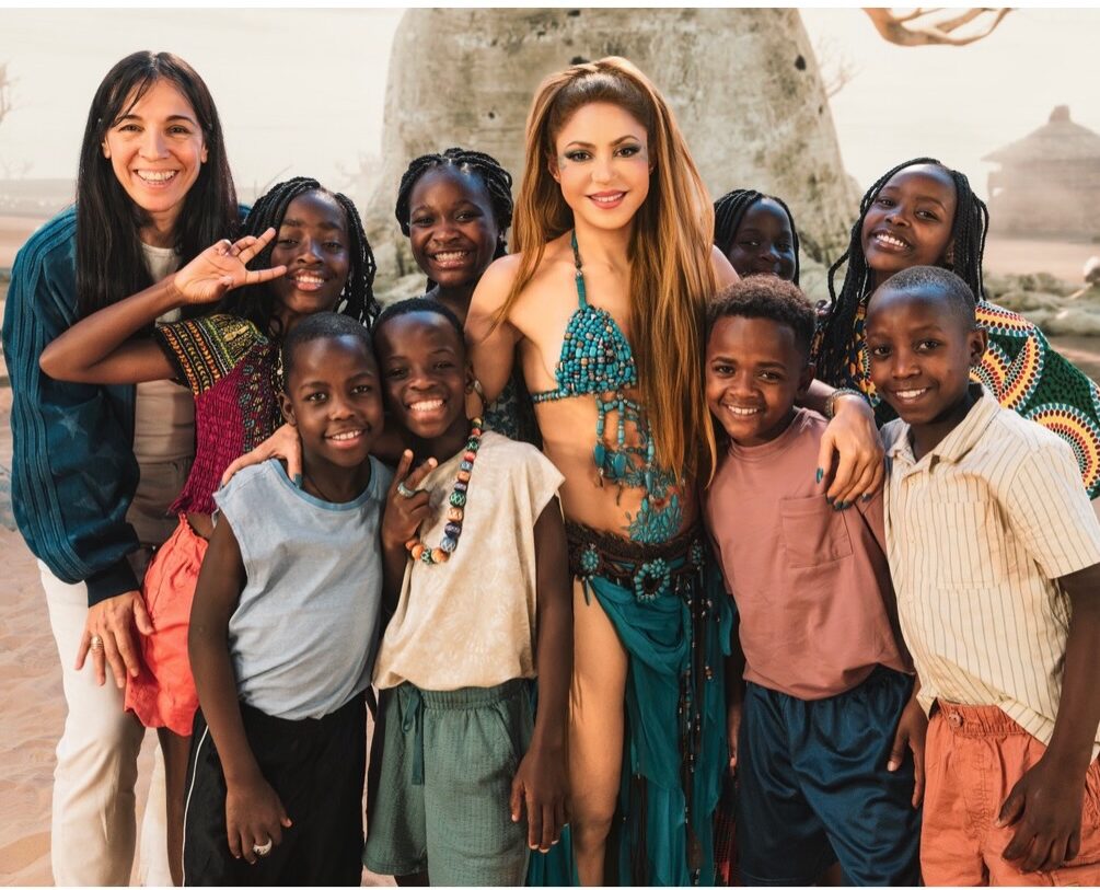 Colombian singer Shakira posing for a group photo with Uganda’s Ghetto Kids on the set of the Dai Dai official 2026 FIFA World Cup anthem music video.