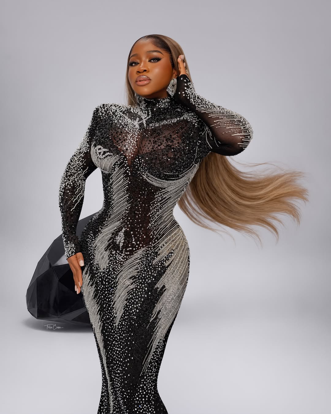 Close-up of Nigerian designer Veekee James highlighting the structured neckline and silver rhinestone details of her birthday gown.