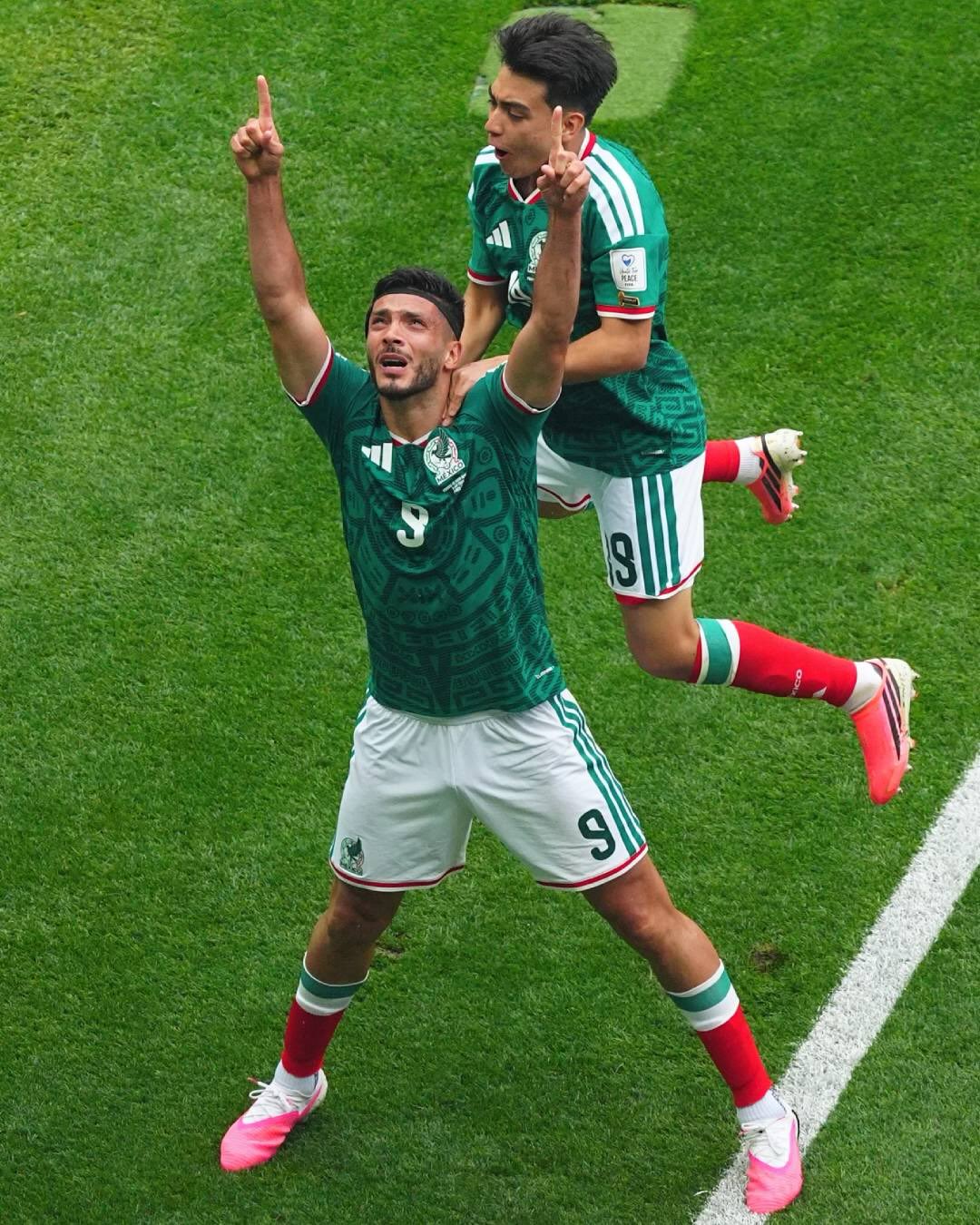 Raúl Jiménez of Mexico celebrating his first World Cup goal on the pitch at Estadio Azteca.