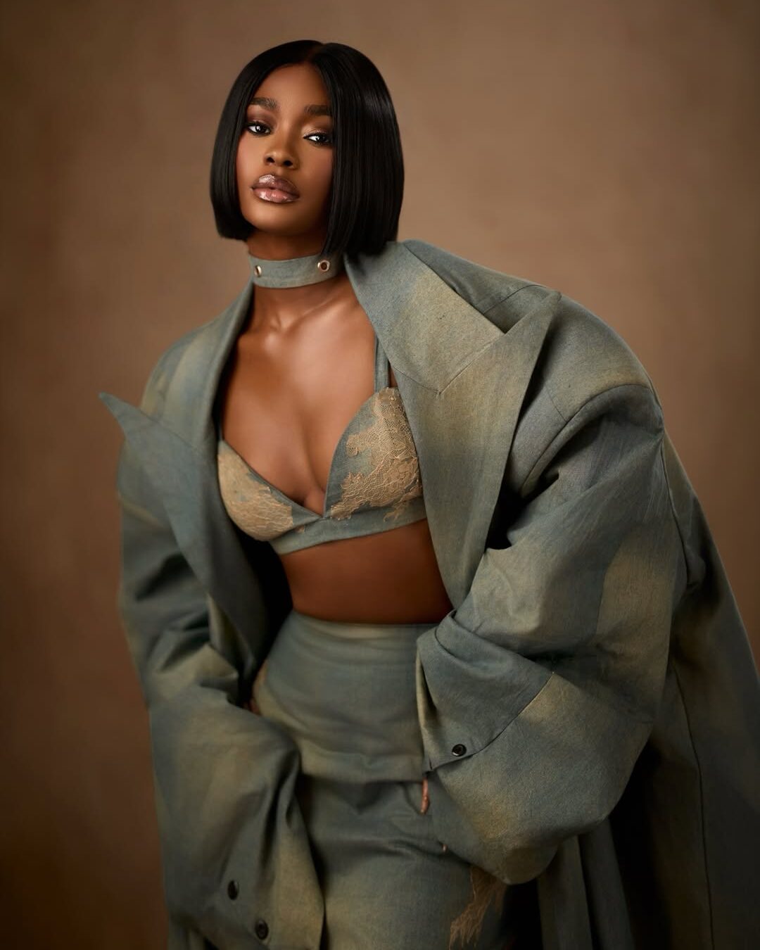 Dede Ashiogwu's BBNaija Season 10 reunion glam featuring a razor-sharp black bob, denim choker, and detailed floral lace on her bralette.