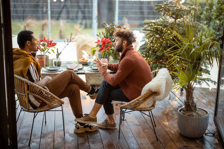 man with presence confidence sitting and talking to another man