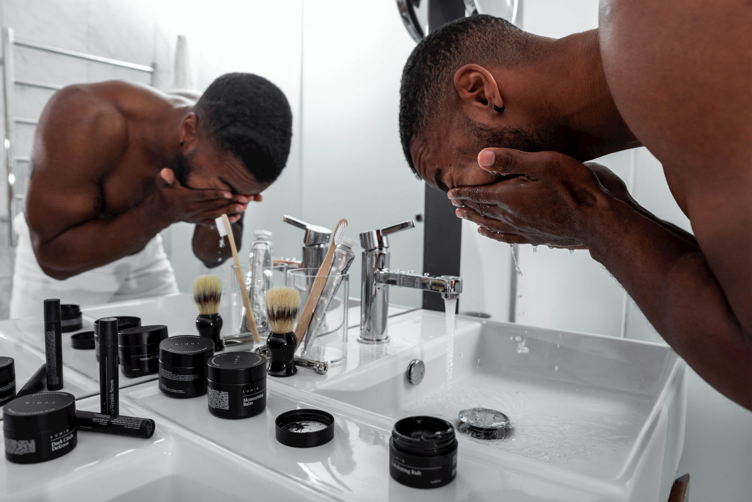 modern man applying skincare grooming in front of mirror