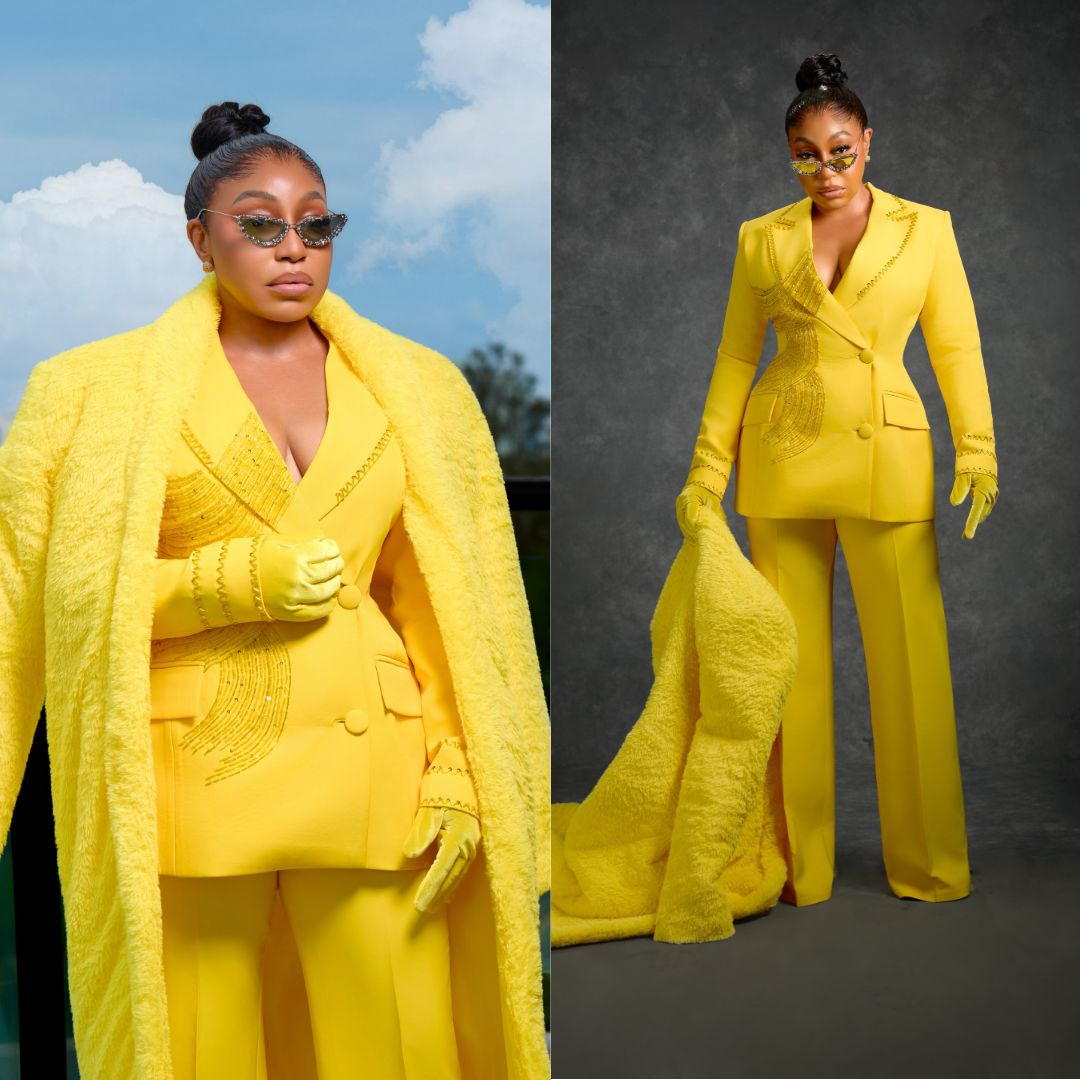Rita Dominic wearing a monochromatic custom yellow Medlin Couture pantsuit featuring a beaded double-breasted blazer, matching satin gloves, and a plush faux-fur coat.