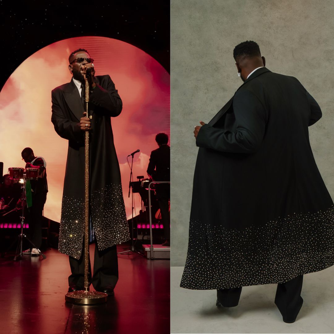 Adekunle Gold performing at his Live with Orchestra concert in Toronto in a black double-breasted tuxedo overcoat with crystal ombre embellishments.