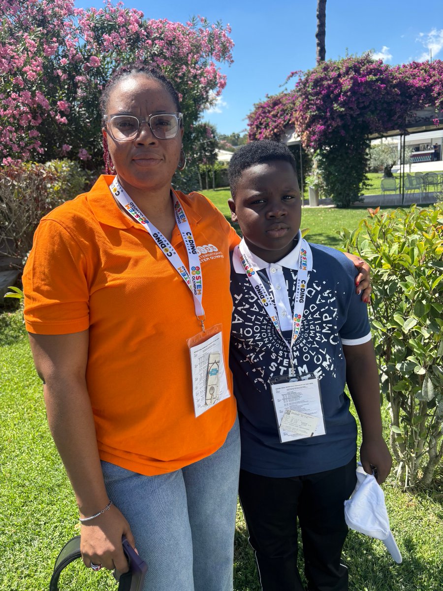 Eleven-year-old gold medalist Egejurum Onyedikachi Ethan standing outdoors with his mother at the STEM Olympiad in Rome.