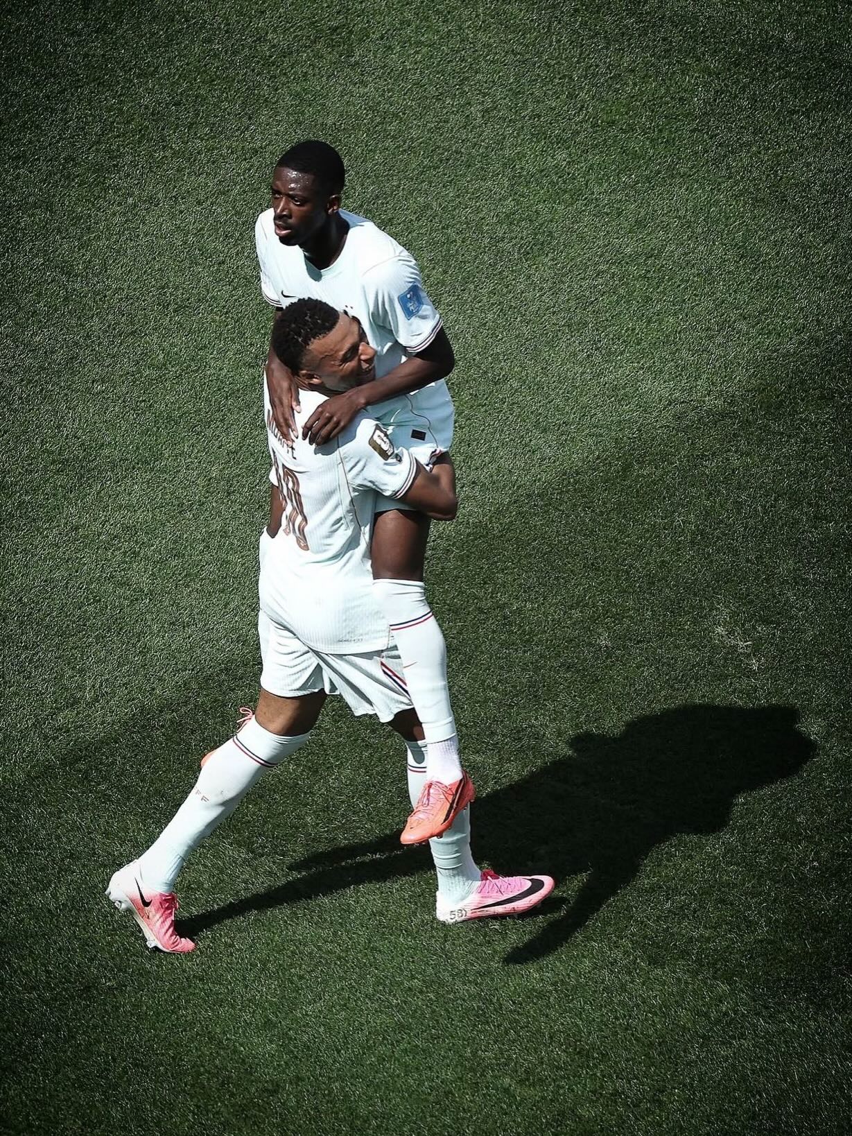 Ousmane Dembele of Malian, Mauritanian, and Senegalese heritage carries Kylian Mbappe on his back while celebrating a French national team goal during the 2026 FIFA World Cup.
