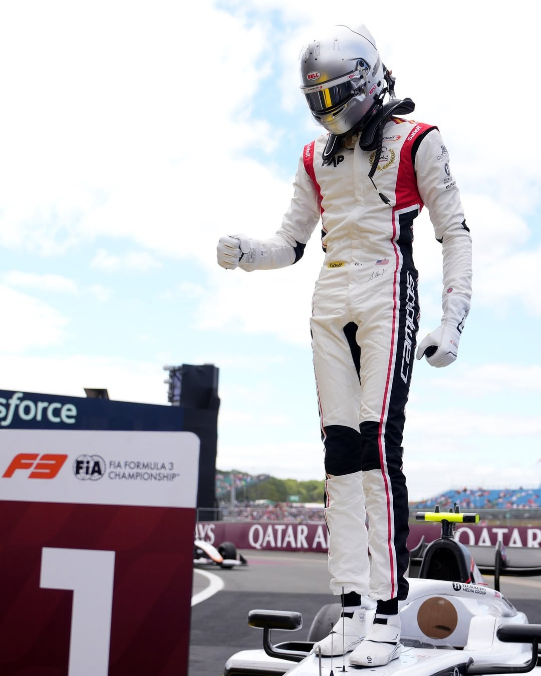 Ugo Ugochukwu standing on his Campos Racing car celebrating his victory at the FIA Formula 3 Championship in Silverstone.