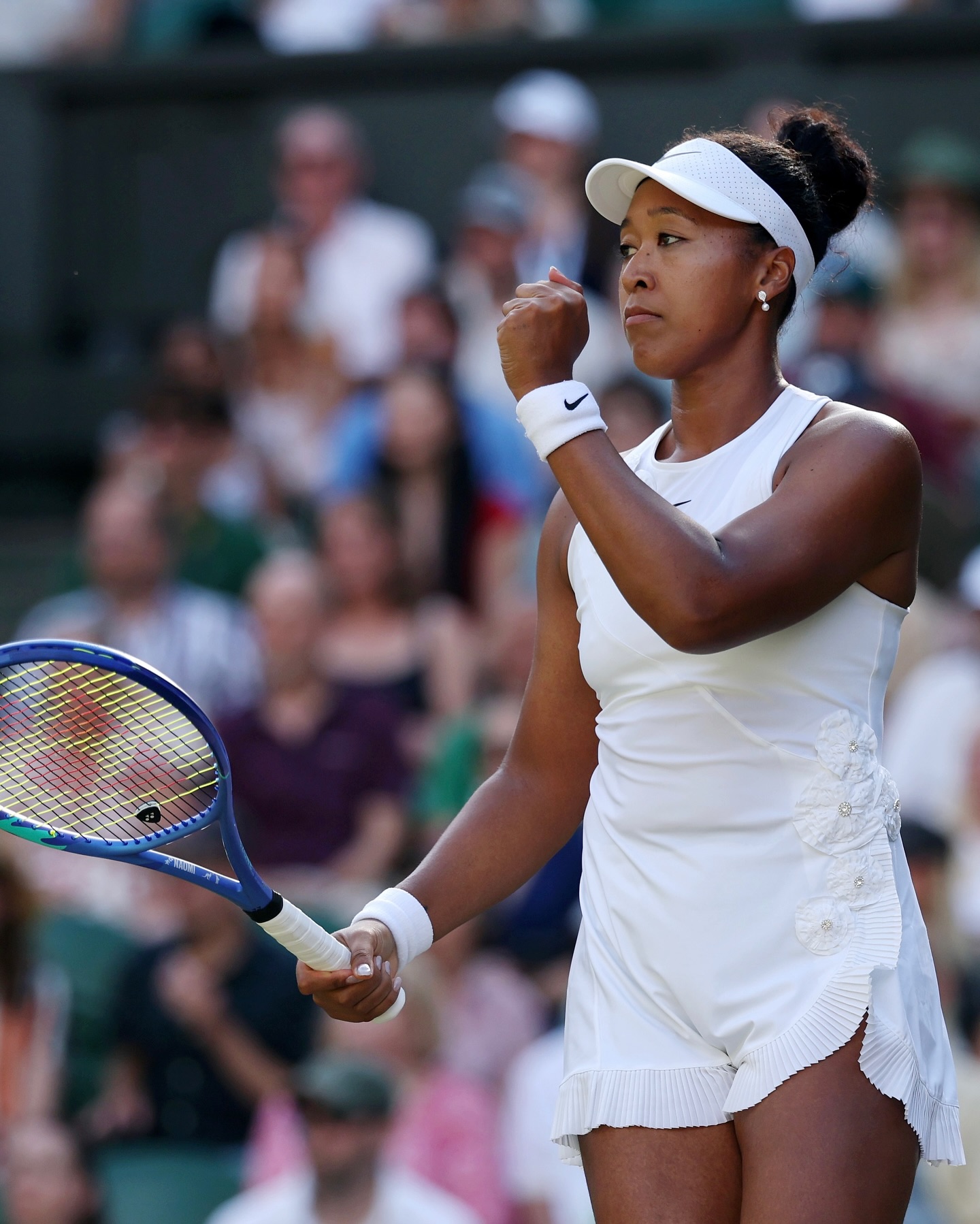 Naomi Osaka pumps her fist celebrating a point against Aryna Sabalenka during her Wimbledon 2026 fourth round match on Centre Court.