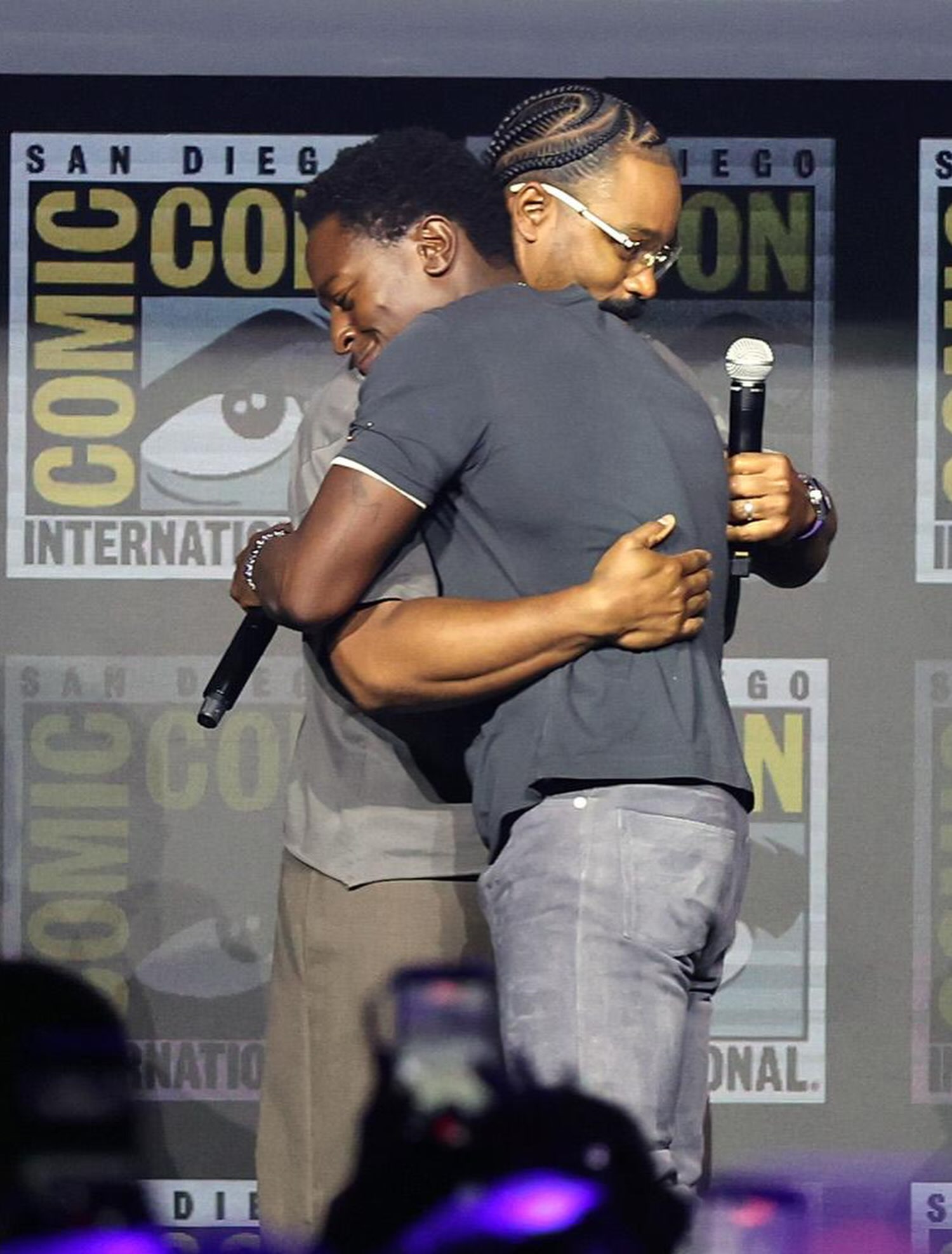 British actor David Jonsson embracing director Ryan Coogler on stage at San Diego Comic-Con 2026 following his announcement as Prince T'Challa II in Black Panther 3.