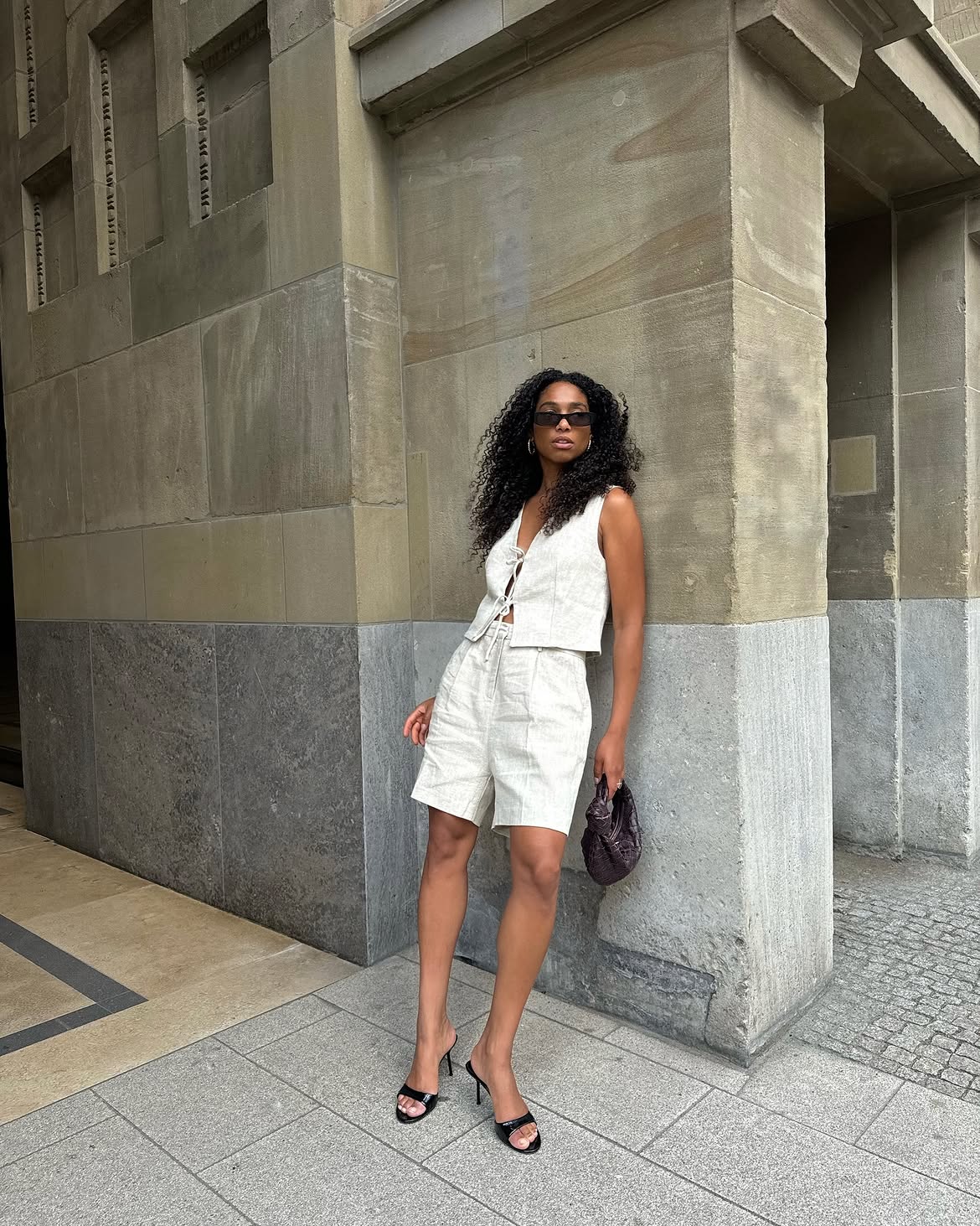 woman wearing white vest and shorts matching set