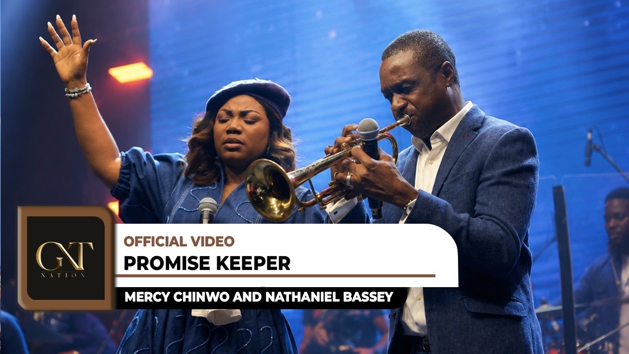 Mercy Chinwo raising her hand in worship next to Nathaniel Bassey playing the trumpet in the official Promise Keeper music video.